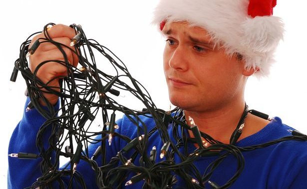 payman-holding-tangled-christmas-tree-lights